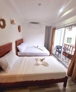 Postel nebo postele na pokoji v ubytování CiNta Hotel