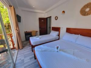 Postel nebo postele na pokoji v ubytování CiNta Hotel
