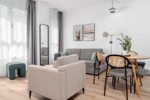 a living room with a couch and a table and chairs at limehome Valencia Carrer d'Antonio Ferrandis in Valencia