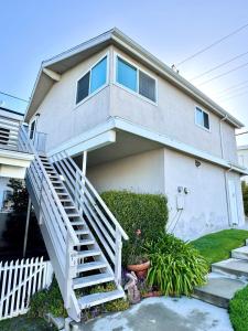 une maison avec un escalier en face de celle-ci dans l'établissement Heart of Corona Del Mar 10 minute walk to beach steps to downtown, à Newport Beach