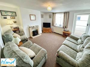 a living room with two couches and a television at St Catherines View in Ventnor