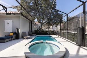 a swimming pool in a glass house with a patio at W456 - Gleaming Retreat With Private Pool at Reunion in Kissimmee