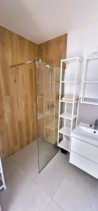 a bathroom with a shower and a sink at Na Pokładzie in Dębki