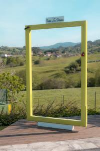 a yellow mirror with a view of a field at Casa La Serena in Lusa