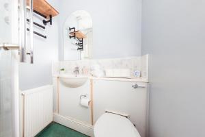 a small bathroom with a sink and a toilet at Warm&Welcoming City Centre Apartments by Meadows 8 in Edinburgh