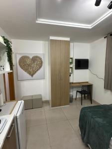 a room with a bed and a cabinet with a heart on the wall at Casa Mauá 312 in Rio de Janeiro