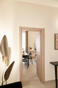 a room with a door leading into a dining room at Casa Altarocca - Home Design in Tarquinia