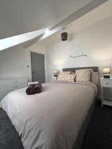 a bedroom with a large white bed in a room at Rock Park Penthouse in Llandrindod Wells