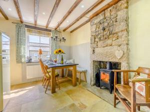 a dining room with a table and a fireplace at 3 Bed in Harbottle 75083 in Harbottle