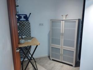a glass cabinet in a room with a table at Le Grand Large in Dieppe +10 photos