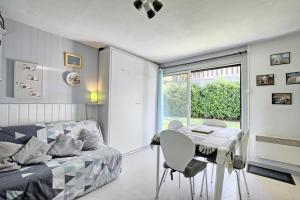 a bedroom with a bed and a table and a window at Studio st-lary in Saint-Lary-Soulan