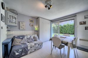 a bedroom with a bed and a table and a window at Studio st-lary in Saint-Lary-Soulan