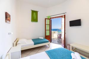 Postel nebo postele na pokoji v ubytování Froudi Rooms