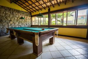 a large room with a pool table in it at Pousada Pontal da Praia in São Pedro da Aldeia