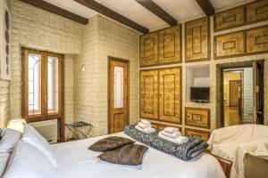 a bedroom with a bed with towels on it at Fontana di Trevi Charming Apartment in Rome