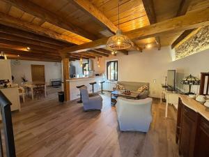 a large living room with wooden ceilings and a table and chairs at La Casa de la Abuela Concha in Felmín +29 photos