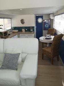 a living room with a white couch and a table at Bateau Mama Mia in Narbonne