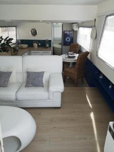 a living room with a couch and a table at Bateau Mama Mia in Narbonne