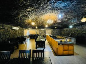 a restaurant with tables and chairs in a cave at The Four Season Beach Resort - Best Selling Property in Gokarna in Gokarna