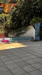 a pink toy is laying on the ground in a courtyard at Cantinho do Sossego in Rio de Janeiro