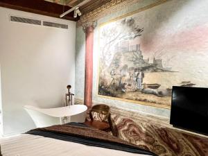 a bedroom with a large painting on the wall at Anahita Boutique Hotel in Málaga