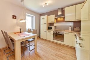 a kitchen with a wooden table and a dining room at Cafe Rosi Ferienwohnung in Bernkastel-Kues