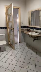 a bathroom with a sink and a toilet and a mirror at Cantinho do Sossego in Rio de Janeiro