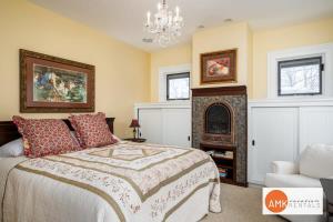 a bedroom with a large bed and a fireplace at Haven on Howard in Grand Haven