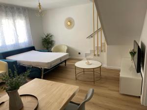 a small room with a bed and a table at BULEVAR SUITE in Nava de la Asunción