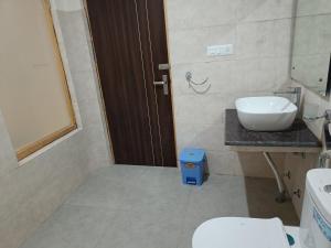 a bathroom with a sink and a toilet at Apricuss hotel in Leh