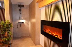 a fireplace in a bathroom with a shower at Gasthof zum Ritter - a cozy historical Landmark in Ulm