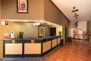 a lobby of a hotel with a reception counter at Ibis Oujda in Oujda