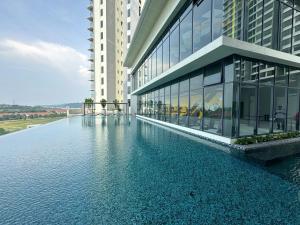 a building with a pool of water in front of it at Setia Alam The Forum By GoMain // Next to SCCC in Shah Alam