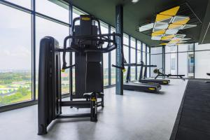 a gym with several tread machines and windows at Setia Alam The Forum By GoMain // Next to SCCC in Shah Alam