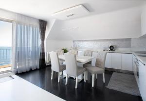 a kitchen and dining room with a table and chairs at NEA Penthouse in Ahtopol