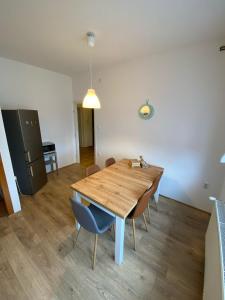 a kitchen and dining room with a wooden table and chairs at Moon Tree *** in Varaždin
