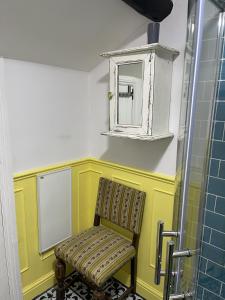 a bathroom with a chair and a medicine cabinet at Stunning 2-bedroomed Cottage in Cockermouth +23 photos