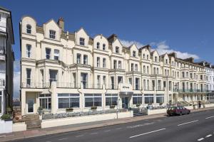 a large white building on the side of a street at The Majestic Hotel in Eastbourne