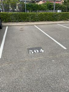 a parking lot with a handicapped sign on the ground at résidence les amandines in Gruissan +2 photos