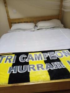a bed with a sign that reads fire camp equipment at Merricks Guest House in Litein