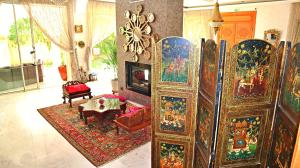 a living room with a bunch of paintings on the wall at Barthélemy Guest House in Marrakech