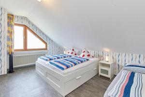 a white bedroom with two beds and a window at Cafe Rosi in Bernkastel-Kues