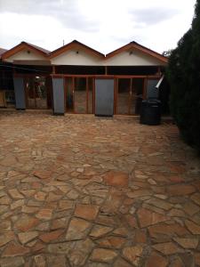a stone patio in front of a house at Merricks Guest House in Litein