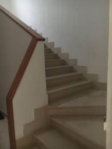 a staircase in a house with a stair case at Appartement simple et propre in Sfax