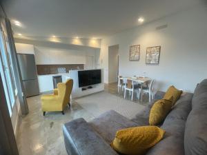 a living room with a couch and a dining room at Ventana del Nublo 2-I in Tejeda