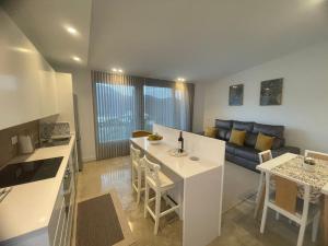 a kitchen and a living room with a couch at Ventana del Nublo 2-I in Tejeda