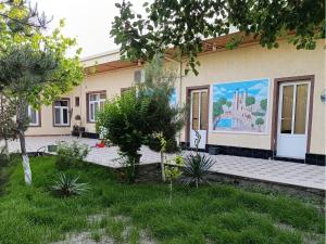 a house with a mural on the side of it at Dilnura Guest House in Bukhara