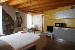 a bedroom with a bed and a kitchen with a table at Trauner Rooms Collection in Trieste