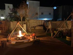a fire pit in a yard at night at The Way Hostel double Room in Dahab