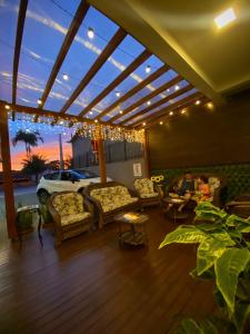 a living room with couches and a patio at Pousada Villa Vantino in Penha